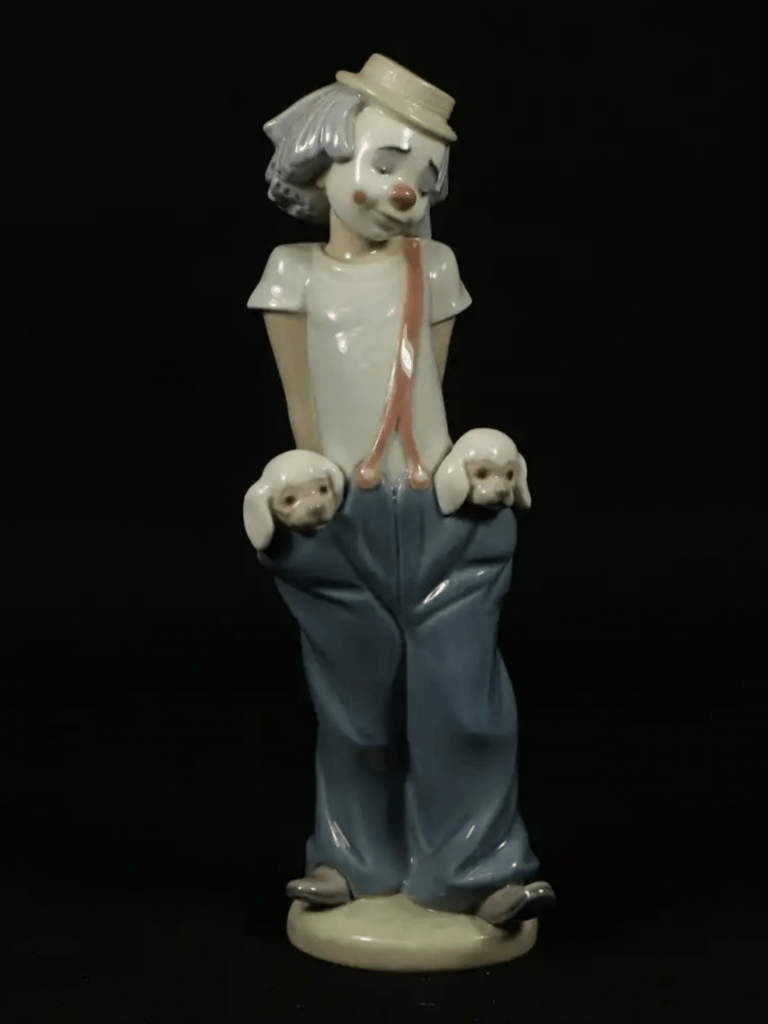 Porcelain clown with puppies in pockets, possibly Lladro or Nao appraisal